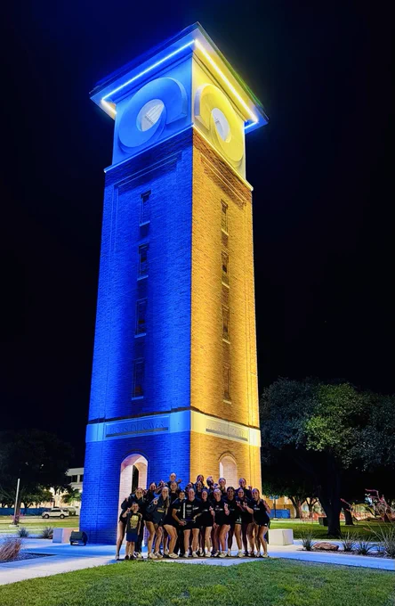 ASU Softball team with trophy at Housley Bell Tower.