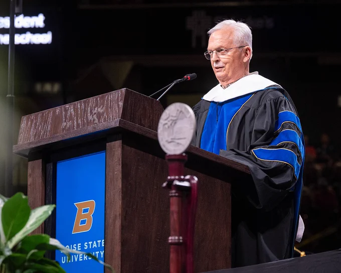 Bruce Newcomb an Honorary Doctor of Laws from Boise State University addressing the crowd during the Spring 2026 Commencement ceremony.
