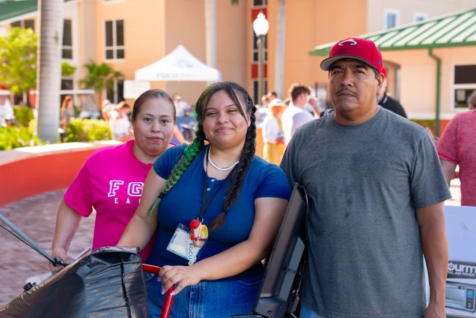 a photo of a family smiling at move-in