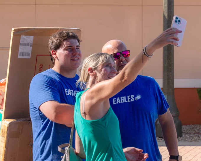 a photo of a family taking a selfie at move-in