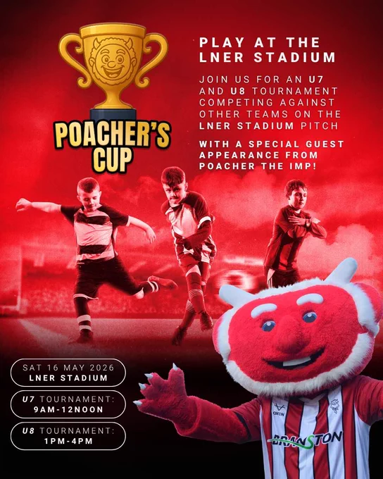 Young football players compete on a stadium pitch with a large red mascot smiling in the foreground during the Poacher's Cup event.