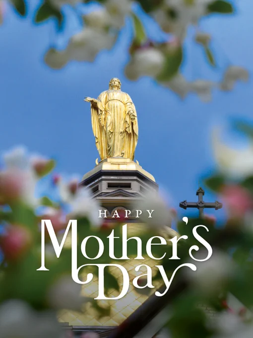 A golden statue atop the University of Notre Dame building, framed by flowering branches. The words "Happy Mother's Day" are overlaid on the image.