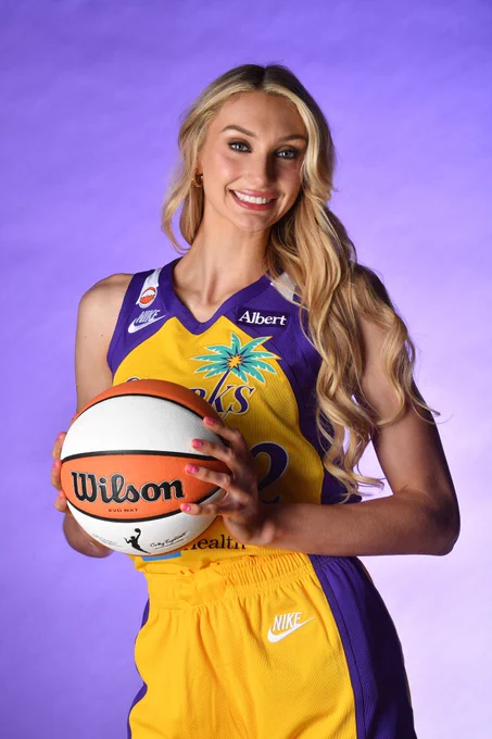 Cameron Brink smiling wearing her sparks Uni and holding a basketball