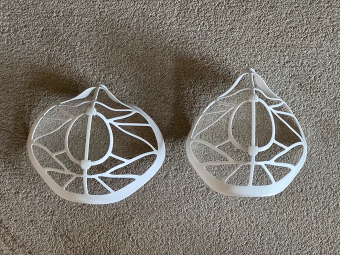 Two Zimi XL mask frames; on the left is the out-of-the-bag wide fit, and on the right is one that’s dramatically narrower with a pronounced nose bridge.