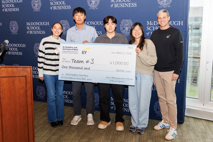 Winners holding their award.