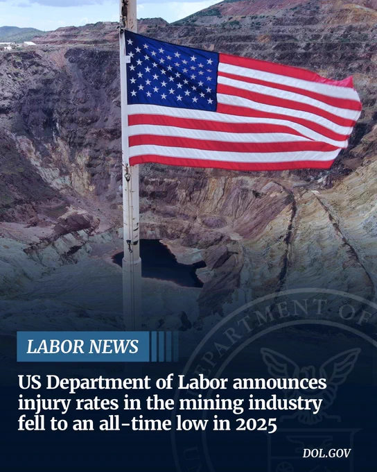 Photo of an American flag flying in front of a large surface mine. "Labor News: US Department of Labor announces injury rates in the mining industry fell to an all-time low in 2025. dol.gov"