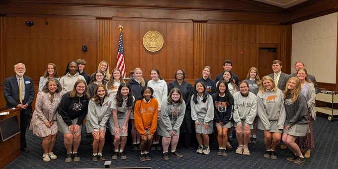 Students gather around U.S. Magistrate Judge Sonja Bivins and attorneys at the federal courthouse in Mobile, Alabama.