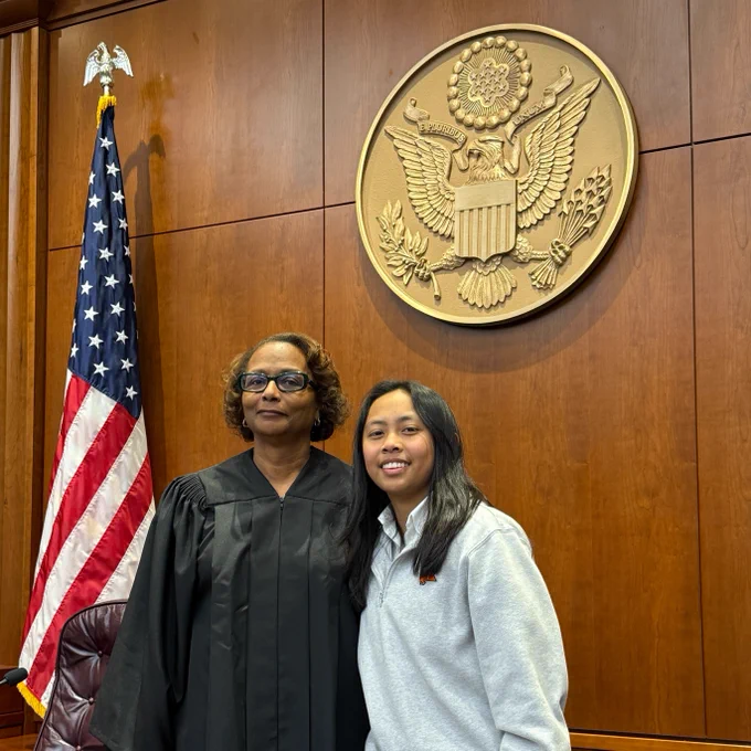 U.S. Magistrate Judge Sonja Bivins (left) stands next to a student following a civics program at the federal courthouse.