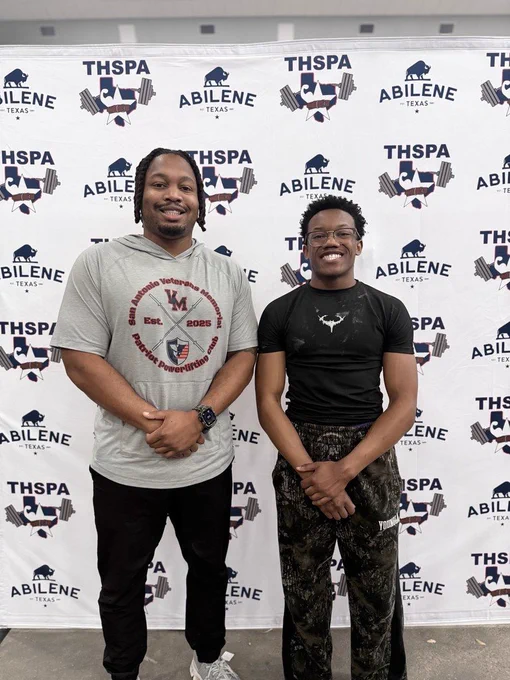 Coach Crochran and Justis Riggs standing in front of the THSPA banner backdrop at the Abilene state tournament.
