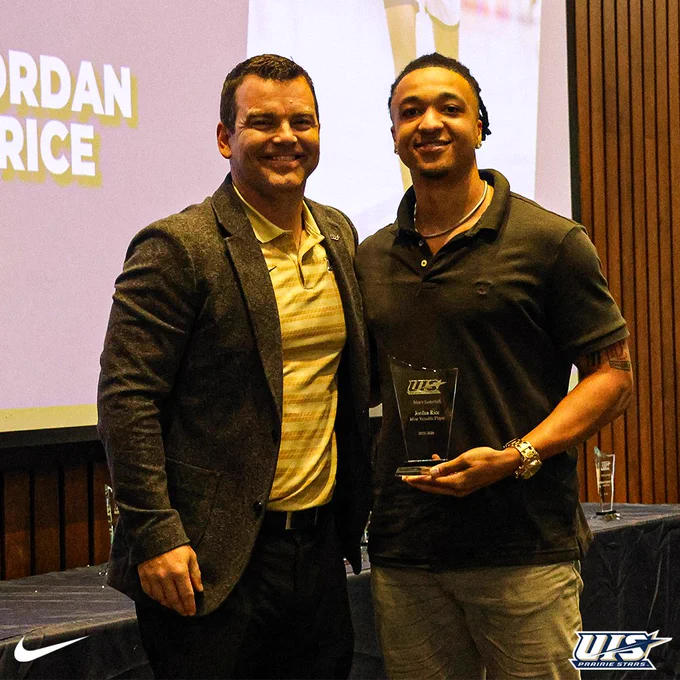 Jordan Rice poses with a coach at the Night of the Stars banquet while holding his MVP award, with his name shown on the screen behind them.