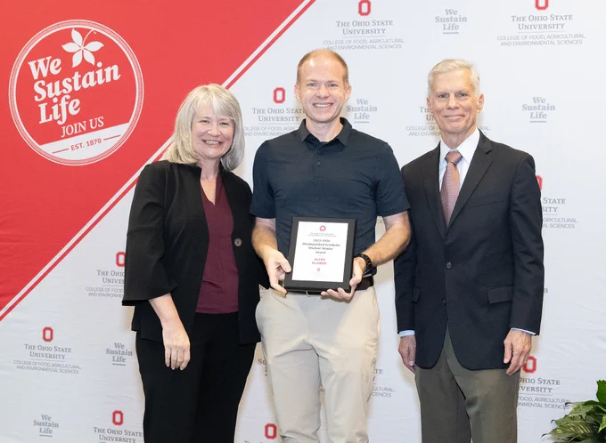 Allen Klaiber receives a College of Food, Agricultural, and Environmental Sciences Award plaque.