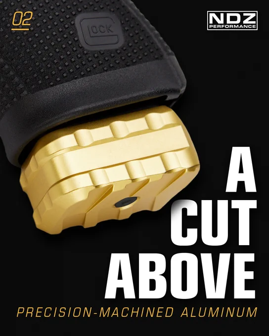 Close-up of NDZ Performance gold magazine extension showing precision-machined aluminum construction on Glock pistol