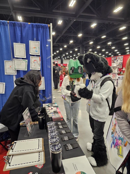 Photo from VCAD’s booth at Calgary Fan Expo showing attendees, cosplayers, and artists engaging in creative activities, character sketch experiences, and interactive design challenges while exploring art, imagination, and community at the event.