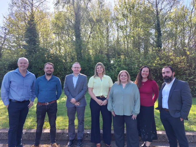 Group of Murphy Geospatial staff standing outdoors welcoming Crystal Nussbaum from Woolpert to the Kilcullen office.