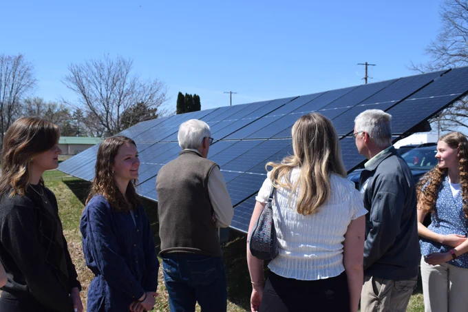 Gov. Evers looks at solar panels outside