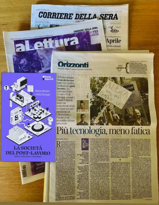 Italian translation of Post-Work, alongside a hard copy newspaper containing an interview with the authors.