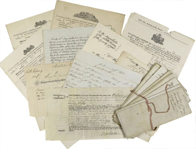Overlapping documents on cream paper, featuring handwritten notes, official crests, and a small bundle tied with string on a white background.