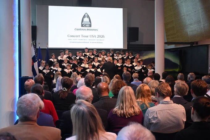 Audience sitting down and listening to a large boys’ choir.
