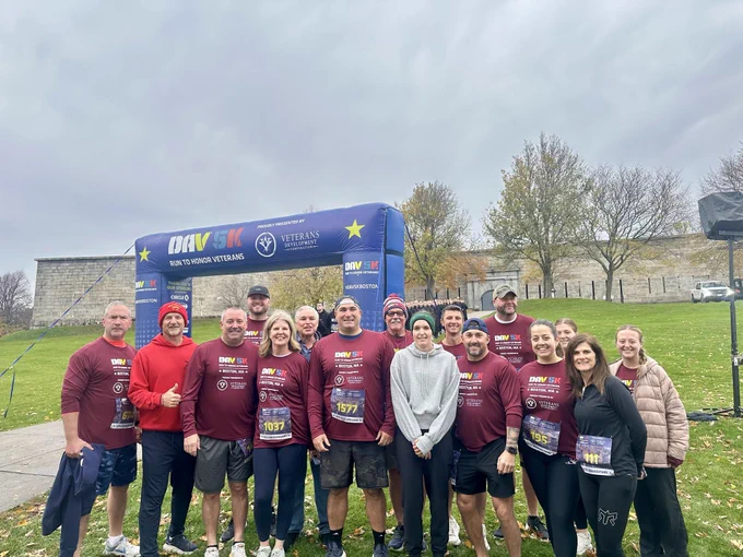 A group of Eversource employees stand together at the DAV 5K Run in Boston to Honor Veterans.