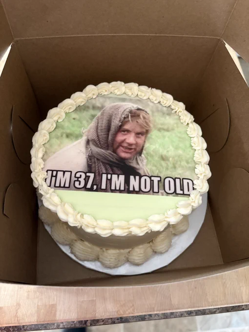 A birthday cake with a Monty Python and the Holy Grail meme of Dennis the Peasant saying “I’m 37, I’m not old”.