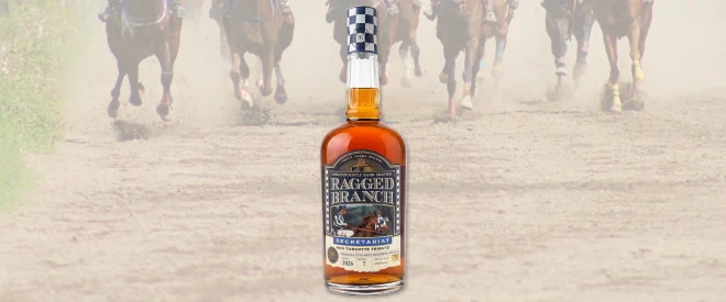 A bottle of spirits superimposed in front of a horse racing track with several horses.