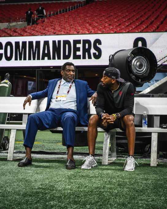 Photo of Doug and D.J. Williams at a Commanders vs. Falcons game. Doug is with the Commanders and D.J. is with the Falcons. 