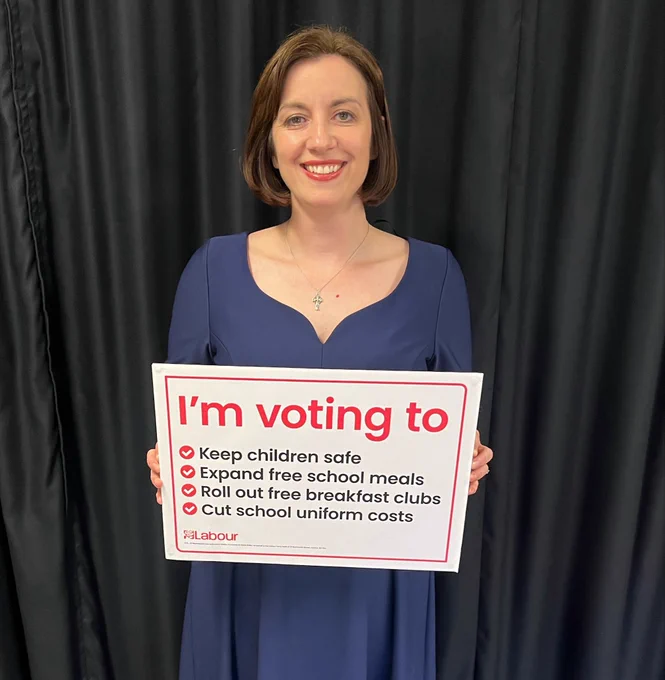 Bridget Phillipson holding a sign in support of the Children’s Wellbeing & Schools Act.