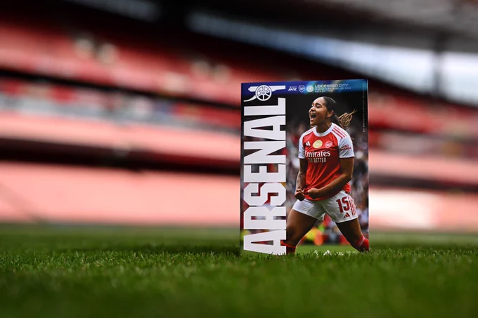 The matchday programme resting on the Emirates pitch this evening - featuring Olivia Smith celebrating her goal against OL Lyonnes on the cover
