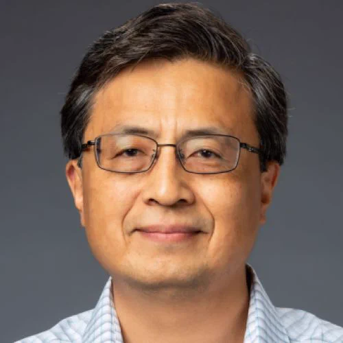 Professional headshot portrait of Josh Huang, PhD, in front of a gray background.