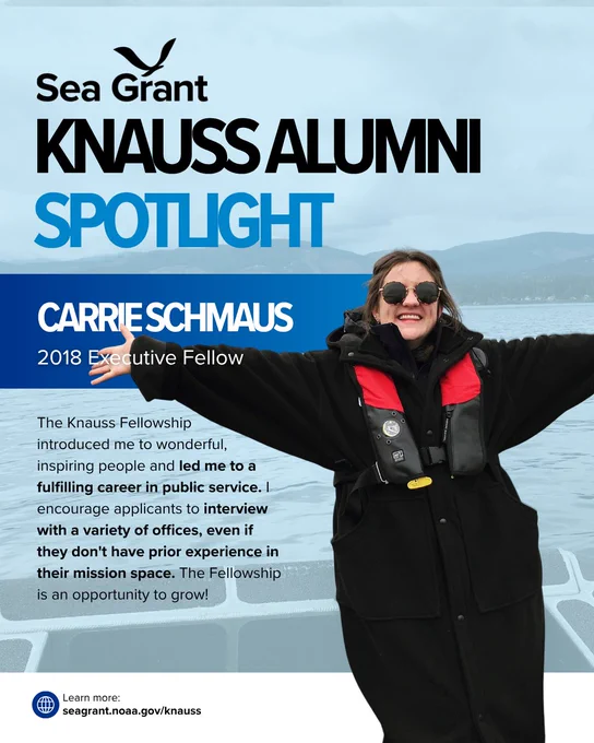 A Sea Grant "Knauss Alumni Spotlight" card for Carrie Schmaus, a 2018 Executive Fellow. The card features a photo of Carrie outdoors on a boat, smiling with her arms outstretched, wearing sunglasses and a black coat over a red life vest with mountains and water in the background.

The text reads: "The Knauss Fellowship introduced me to wonderful, inspiring people and led me to a fulfilling career in public service. I encourage applicants to interview with a variety of offices, even if they don't have prior experience in their mission space. The Fellowship is an opportunity to grow!"

Link at bottom: seagrant.noaa.gov/knauss