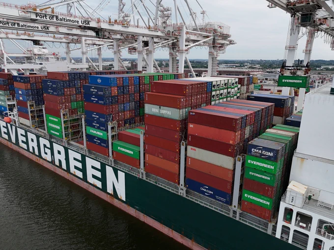 A large Evergreen container ship docked at the Port of Baltimore's Seagirt Marine Terminal is being loaded with shipping containers.