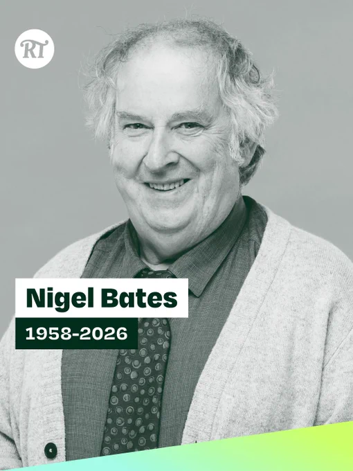 A smiling older man with curly hair wears a cardigan and tie. Text reads "Nigel Bates, 1958-2026" against a grey background, conveying remembrance.
