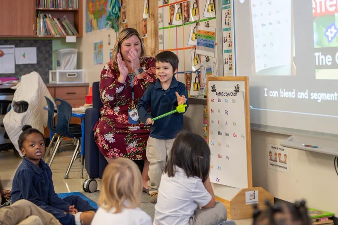 Prekindergarten student and teacher in classroom