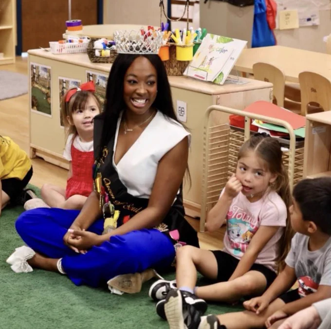 2026 San Antonio Queen of Soul smiling with children.
