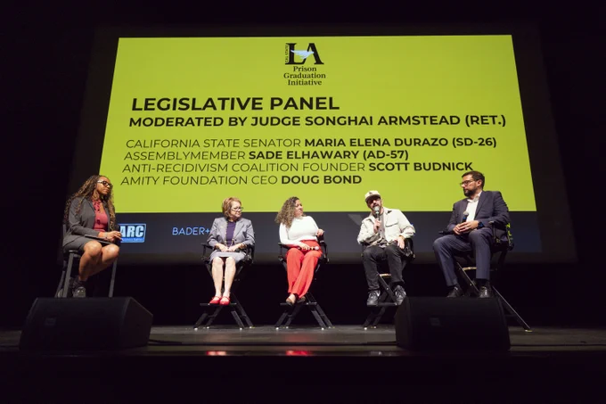 The image shows a panel discussion at the "Prison Graduation Initiative." Five individuals are seated on a stage. A large screen behind them displays the event's title, "Legislative Panel," moderated by Judge Songhai Armstead (Ret.). The screen lists participants: California State Senator Maria Elena Durazo (SD-26), Assemblymember Sade Elhawary (AD-57), Anti-Recidivism Coalition Founder Scott Budnick, and Amity Foundation CEO Doug Bond. The individuals are engaged in a discussion.