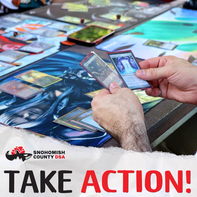 This is a photo of SnoCo DSA members playing Magic the Gathering, a fantasy card game with the text TAKE ACTION.