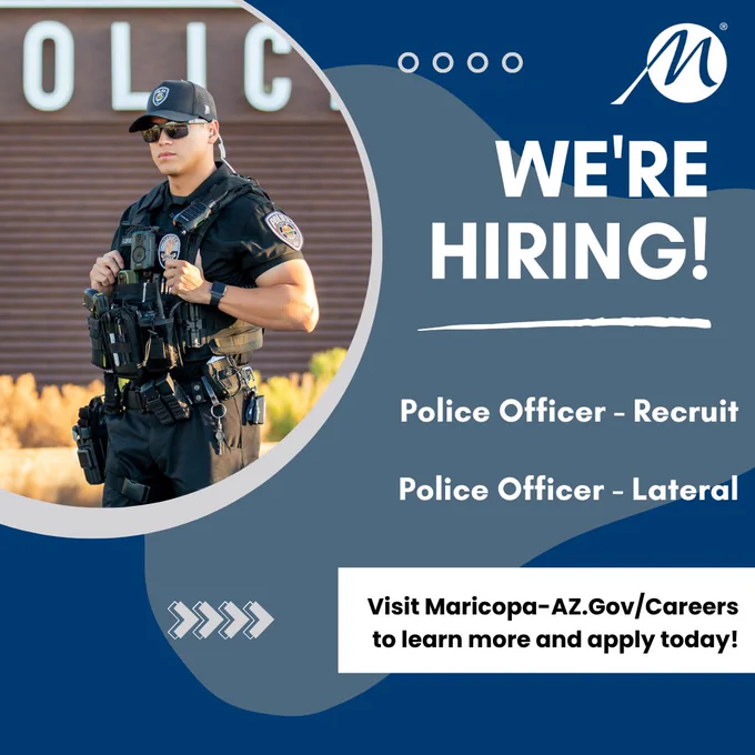 Uniformed police officer standing confidently with tactical gear, promoting hiring for recruit and lateral police officer positions.