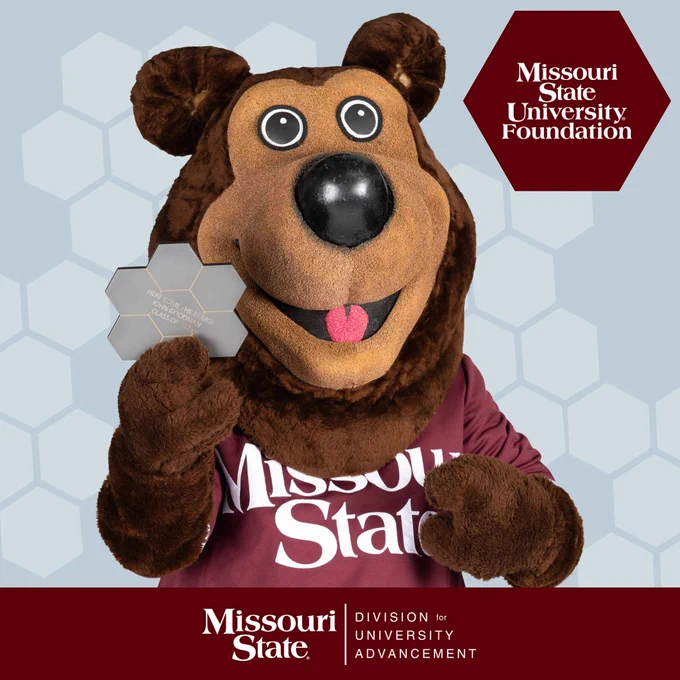 The image features the Missouri State University mascot, a bear character holding a hexagonal award. The bear is wearing a maroon shirt with "Missouri State" on it. In the background, there is a logo for the Missouri State University Foundation.
