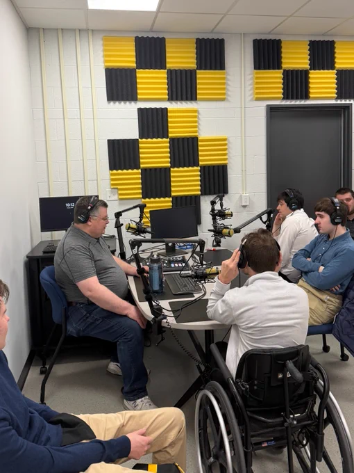 UI REACH students sit around a podcasting table.
