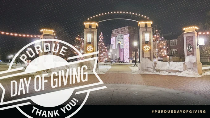 Purdue Memorial Union gateway decorated with holiday lights and snow at night with Purdue Day of Giving Thank You logo overlayed. 