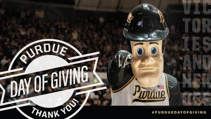 The image shows Purdue University's mascot pointing towards the viewer. A prominent circular graphic reads "Purdue Day of Giving, Thank You!" in white text. In the background, people are visible in a stadium setting. The words "Victories and Heroes" are partially visible on the right side.
