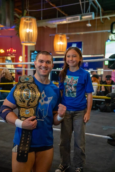 Independent professional wrestler and SoCal Pro Wrestling Heavyweight Champion Mathias taking a picture with fans before his match at CoLab Public House in Vista San Diego, California