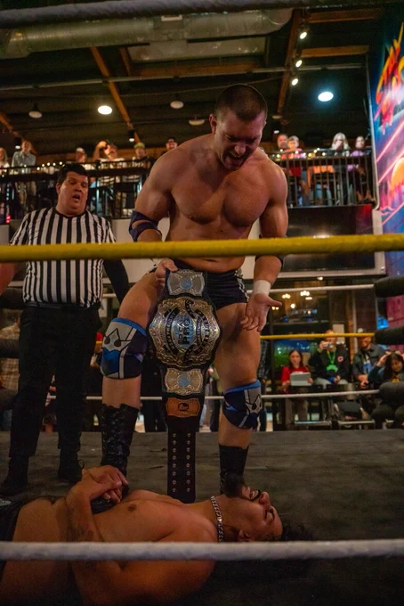 Independent professional wrestler and SoCal Pro Wrestling Heavyweight Champion Mathias posing with his championship title belt after his match at CoLab Public House in Vista San Diego, California