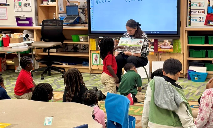 Employee reading to students