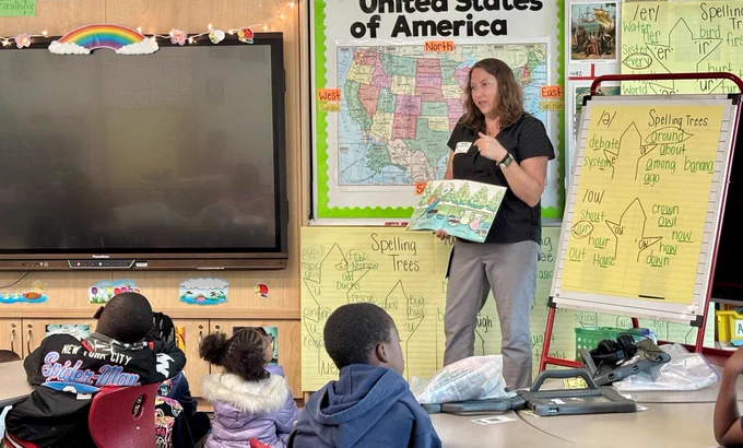 Employee reading to students