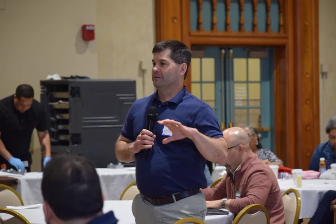 Attendees report out after table discussions. 