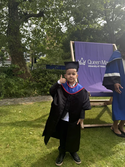 Child in a mini Queen Mary graduation gown