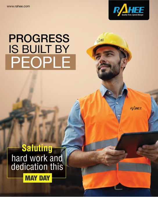 A May Day commemorative graphic by Rahee Group. A male professional wearing a yellow Rahee hard hat and an orange high-visibility vest stands confidently in the foreground holding a digital tablet. Behind him is a softly blurred construction site with heavy machinery. Text on the image reads: "PROGRESS IS BUILT BY PEOPLE" and "Saluting hard work and dedication this MAY DAY." The Rahee company logo is in the top right.