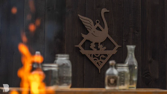 The Dragon Age Cobbled Swan Metal Wall Art features the Tevinter pub’s iconic sign—an elegant swan wearing boots! Feat. a brass finish and a hammered texture.