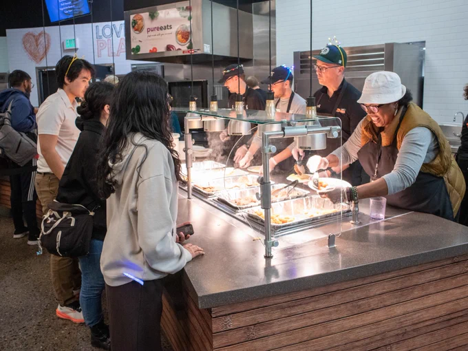 Students waiting in line to get their breakfast plate.